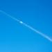 Plane trail crossing the sky over the moon Plane trail crossing the sky over the moon