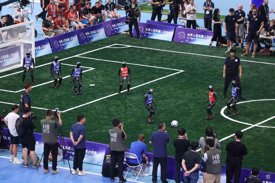 Humanoid robots compete in a football match during the 2025 World Humanoid Robot Games, Aug. 17, 2025. (Photo/Chen Xiaogen)