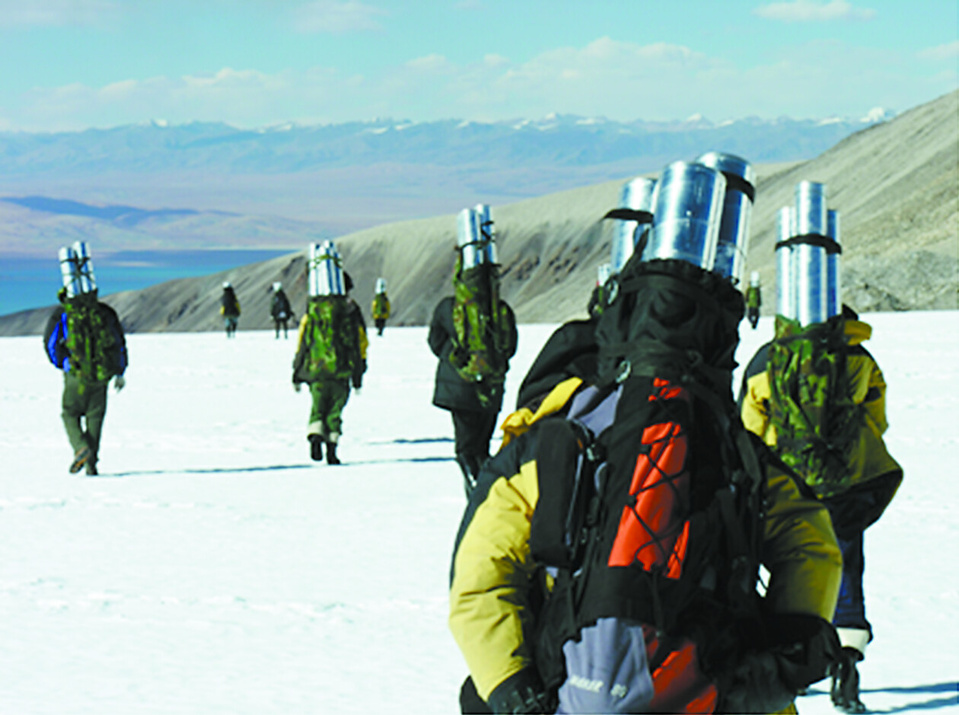 In 2006, members of the China-US joint expedition team carry ice cores from Naimona'nyi back to their base camp. Courtesy of the Institute of Tibetan Plateau Research, Chinese Academy of Sciences
