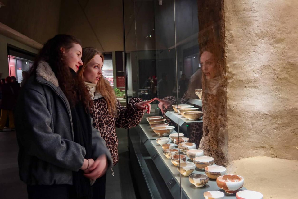 Foreign tourists visit the Miaodigou Museum in Sanmenxia, central China's Henan province. (Photo/Sun Meng)