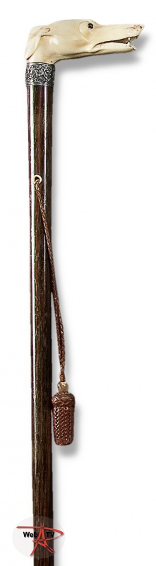 Lot 7 Canne à poignée équerre en ivoire, sculptée en ronde bosse d'une tête de lévrier gueule ouverte tirant la langue, les yeux sont en sulfure © Etude Aguttes